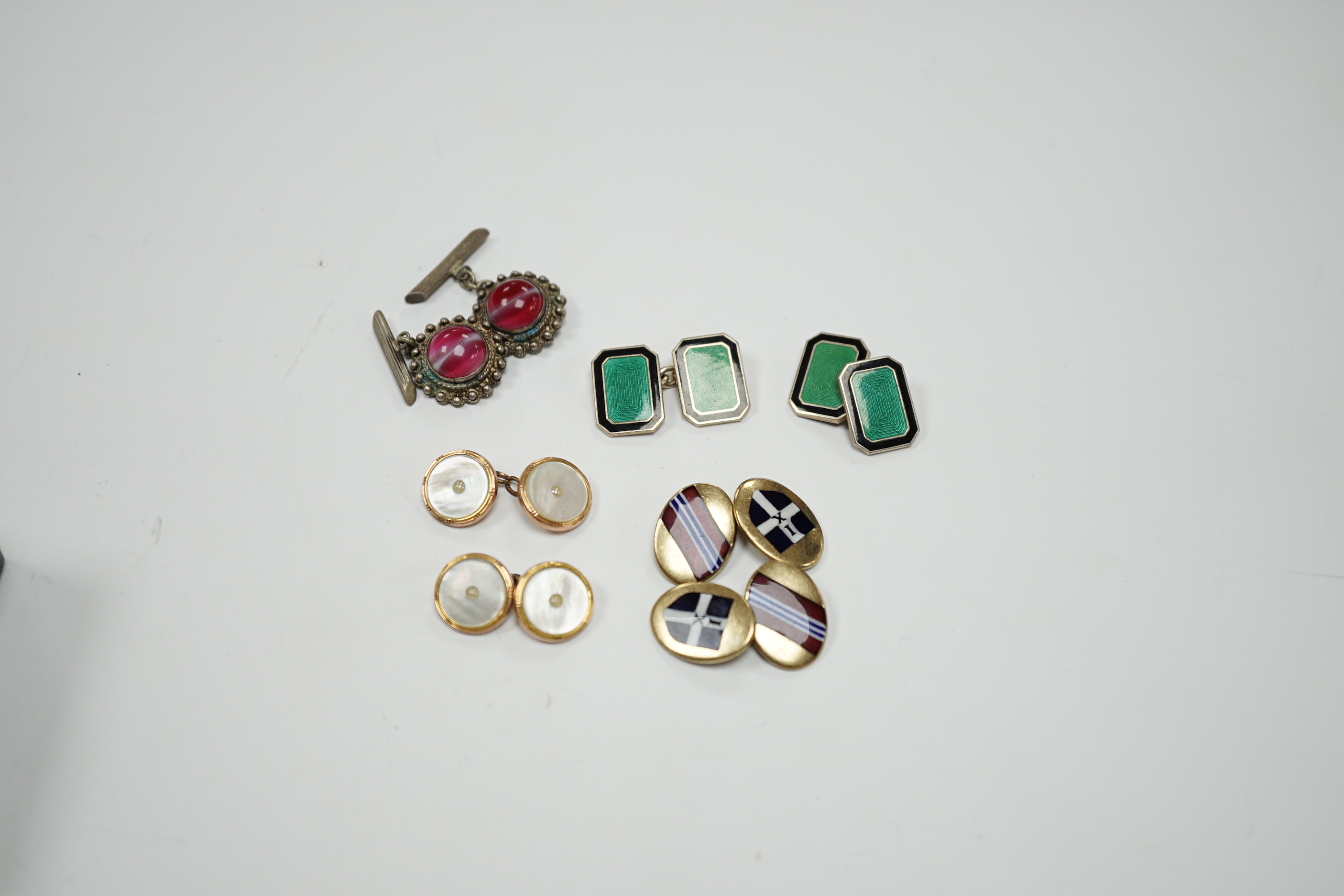 Four assorted pairs of cufflinks including silver and two coloured enamel.